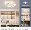 A modern dining room with a stylish ceiling light and a display cabinet filled with wine bottles. A phone screen shows a reflection of the room and the ceiling light. Produktbild-Vorschau