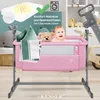 A pink baby bassinet with a baby, teddy bear, and pillows inside, set against a backdrop of nursery items and a washing machine icon. Produktbild-Vorschau