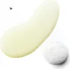 A close-up shot of a yellow liquid product and a small pile of white foam on a white background. Produktbild-Vorschau