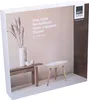 The image shows the packaging of a side table, with a lifestyle-like illustration of the product on the front. The packaging is white with a printed image. Produktbild-Vorschau