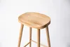 A close-up studio shot of a wooden bar stool against a white background. Produktbild-Vorschau