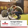 A man is applying lubricant to a bicycle chain in a backyard setting. Produktbild-Vorschau