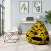 A bean bag chair with a car print is placed in a room with a desk, a window, and plants. Náhľad obrázku produktu