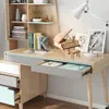 A desk with a wooden piano model, books, and a lamp. Podgląd zdjęcia produktu