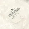 A close-up of a product label inside clear plastic packaging. Produktbild-Vorschau