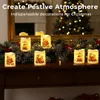 Christmas candles arranged on a wooden surface in front of a mirror reflecting a Christmas tree. Produktbild-Vorschau