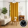 A living room scene with a sofa, coffee table, and a large yellow curtain. Produktbild-Vorschau