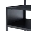 A close-up view of the corner of a black metal shelf unit, showing the texture of the material and the construction of the shelves. Anteprima dell’immagine prodotto