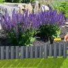 A person is installing a garden border in front of purple flowers and rocks. Náhľad obrázku produktu