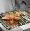 A close-up shot of a steak being grilled on a gas grill, with rosemary sprigs on top. Produktbild-Vorschau
