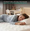 A young girl sleeping peacefully on a mattress in a bedroom. Produktbild-Vorschau
