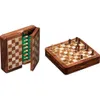 A wooden magnetic chess set is shown, with one half open to reveal the storage compartment for the pieces, and the other half showing the board with pieces set up for a game. Podgląd zdjęcia produktu