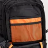 A close-up view of the front pocket of a black backpack with orange mesh and lining. Produktbild-Vorschau