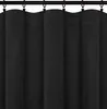 A close-up view of black curtains hanging from a curtain rod. Produktbild-Vorschau