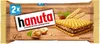 A package of Hanuta Haselnuss Schnitte wafers on a wooden background. Anteprima dell’immagine prodotto