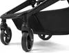 Close-up view of the wheels and storage basket of a stroller. Produktbild-Vorschau