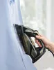 A person is ironing a blue shirt with a steam iron. Produktbild-Vorschau