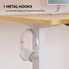 A close-up view of a desk with headphones hanging from a metal hook. Voir les images du produit