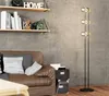 A floor lamp is shown next to a brown leather sofa in a living room setting. Produktbild-Vorschau