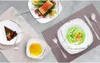 A table setting with plates of food and dessert. Náhled obrázku produktu