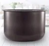 A dark gray inner pot for an Instant Pot sits on a white tiled surface with a blurred background of a kitchen. Náhled obrázku produktu