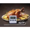 A roasted chicken with potatoes on a platter, with a digital thermometer in the foreground. Voir les images du produit
