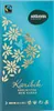 A close-up of a chocolate bar wrapper with decorative floral patterns and text. Náhled obrázku produktu