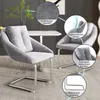 Two gray upholstered dining chairs with chrome cantilever bases are shown in a room setting, with close-up insets highlighting features. Náhľad obrázku produktu