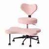 A pink ergonomic meditation chair with a heart-shaped backrest and a bone-shaped seat, shown against a white background. Produktbild-Vorschau