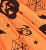 A close-up of an orange fabric with a Halloween pattern. Anteprima dell’immagine prodotto