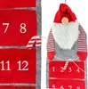 A close-up view of a Christmas advent calendar shaped like a gnome, with numbered pockets and a candy cane marker. Produktbild-Vorschau