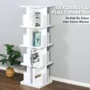 A white rotating bookshelf with books on a wooden floor against a light gray wall. Podgląd zdjęcia produktu