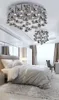 A bedroom with a bed, dresser, and two ceiling lights. Podgląd zdjęcia produktu
