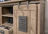 Close-up of a wooden sideboard with a sliding door and a metal plaque. Voir les images du produit
