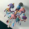 A colorful, cartoon-style chandelier hangs from a white ceiling. Produktbild-Vorschau