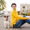 A woman and a dog sitting on the ground outdoors. Náhled obrázku produktu