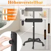 A height-adjustable salon trolley with two trays and tool holders, shown in a room setting with a window view. Voir les images du produit