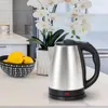 A stainless steel electric kettle sits on a kitchen counter next to a bowl of lemons and a potted orchid. Produktbild-Vorschau