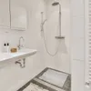 A bathroom with a sink and shower. Náhľad obrázku produktu