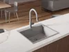 A modern kitchen sink with a faucet installed on a white countertop. Produktbild-Vorschau