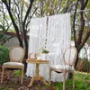 A charming outdoor setting with two chairs and a small table, draped with white lace curtains. Náhľad obrázku produktu