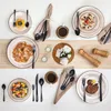 A top-down view of a beautifully set table with multiple place settings, food, and decorative elements. Produktbild-Vorschau