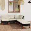 An outdoor lounge set with cream cushions on a tiled patio, next to a wall with a window and macrame wall hanging. Produktbild-Vorschau