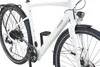 A close-up view of a white electric bicycle, focusing on the frame, wheels, and drivetrain. Produktbild-Vorschau