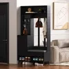 An entryway organizer with a bench and shoe rack is placed next to a door and a sofa. Produktbild-Vorschau