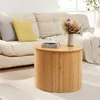 A round coffee table made of bamboo slats is placed in front of a sofa with cushions. A cup of coffee and a vase with dried flowers are on the table. Náhľad obrázku produktu