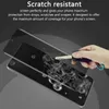 A hand is shown holding a car key, about to scratch a phone screen protector. The phone screen protector is shown on a phone, with scratches on it. Produktbild-Vorschau