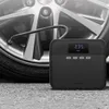 A portable air compressor is shown next to a car tire, with the hose connected to the tire valve. Produktbild-Vorschau
