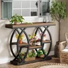 A console table with plants and flowers displayed in a room with a window and chair. Voir les images du produit