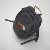 A black backpack is shown open, with a wallet inside. Náhled obrázku produktu